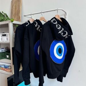 Black Hoodie Sweater with Blue Target Eye Graphic